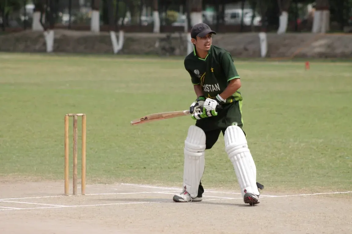 INU cricket team fielding on the ground